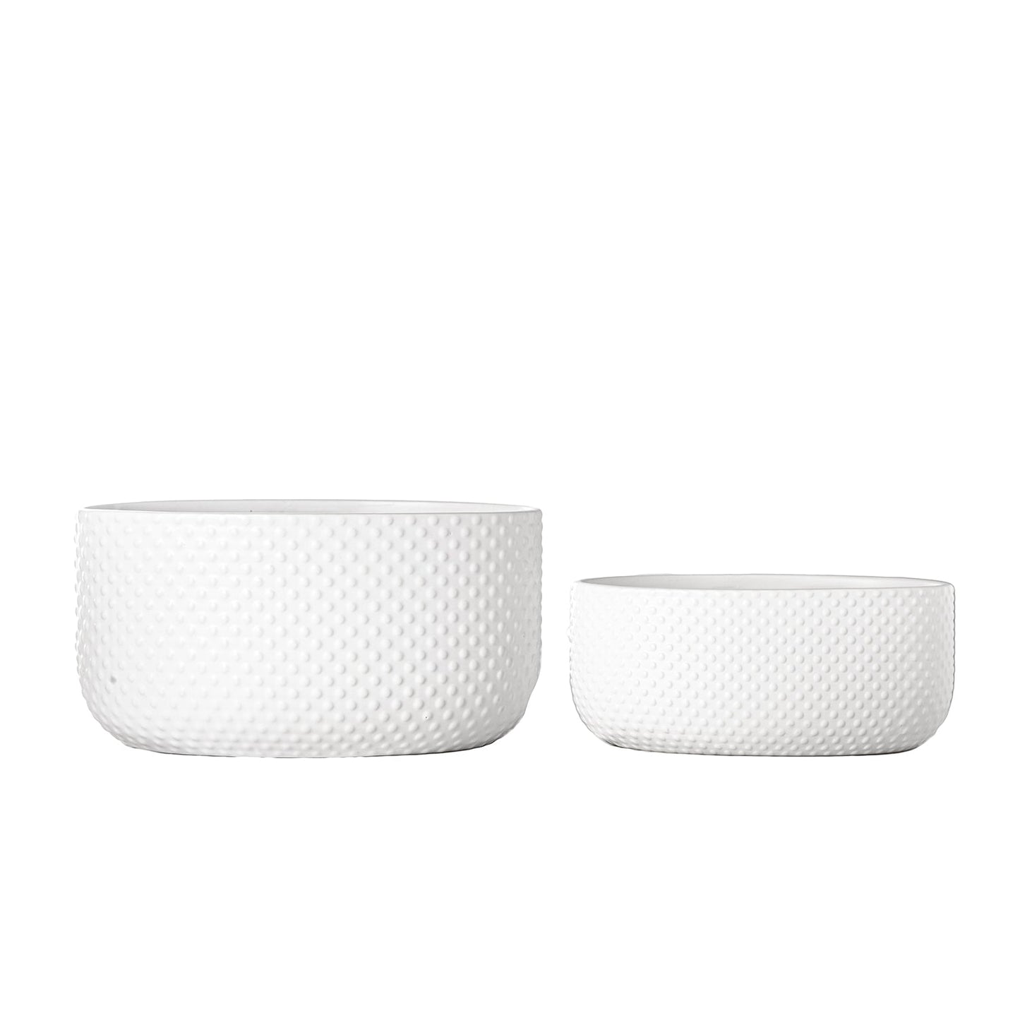 Two white textured ceramic bowls on a white background