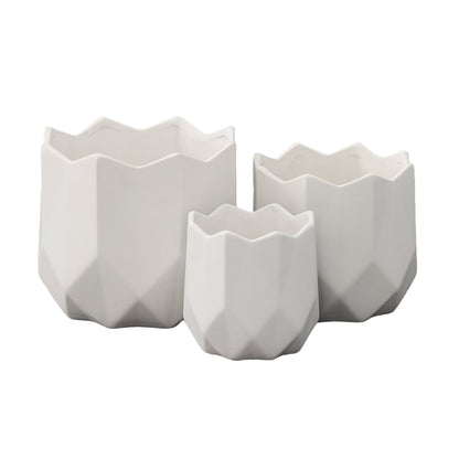 A set of three white ceramic round pots with a matte finish and a geometric design