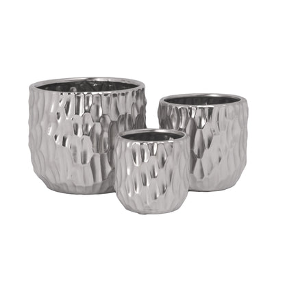Three ceramic round pots with a matte finish, displayed on a surface with a Scooped design body. The pots are white in color and have a textured exterior.