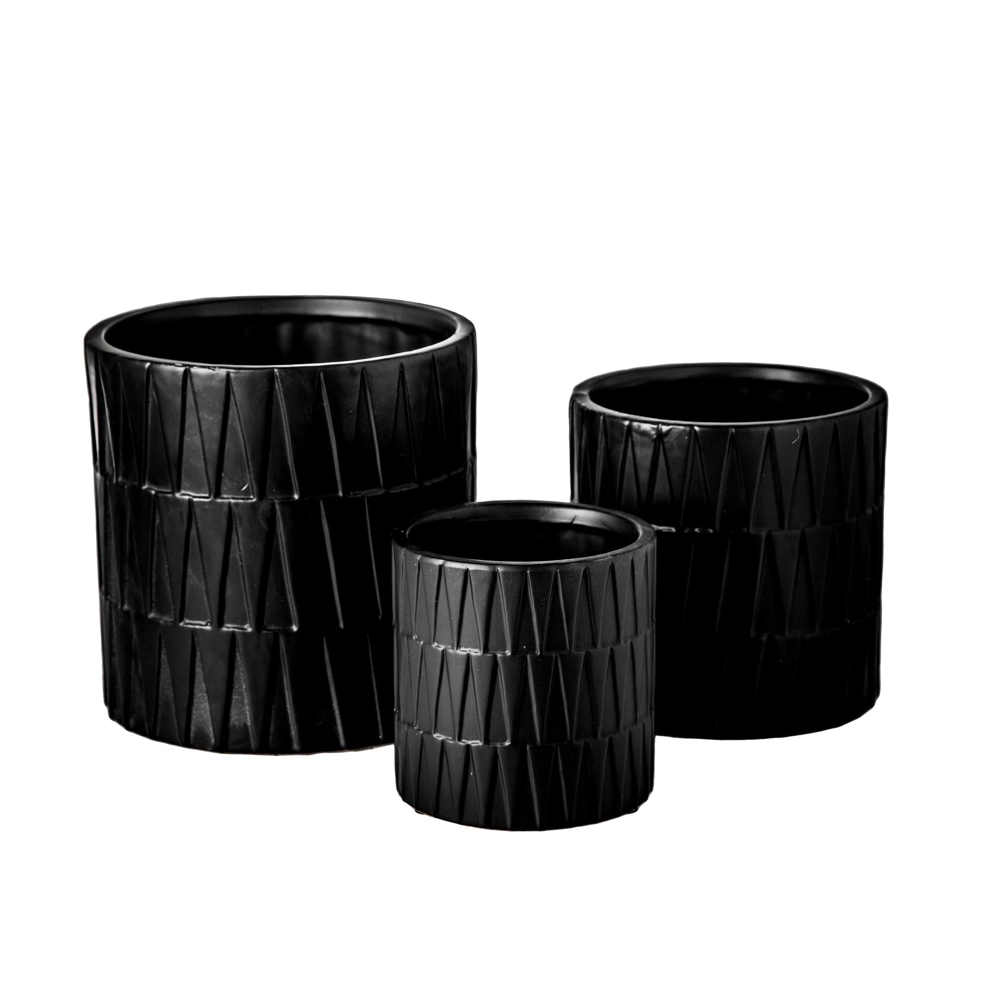 A set of three black ceramic round pots with a matte finish and embossed layered banded spike pattern