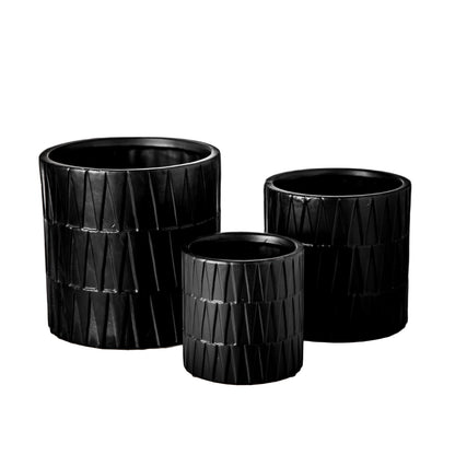 A set of three black ceramic round pots with a matte finish and embossed layered banded spike pattern