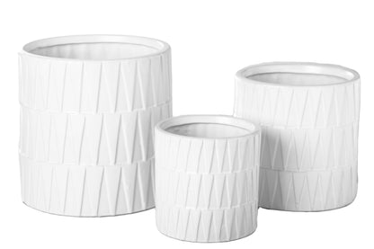 A set of three black ceramic round pots with a matte finish and embossed layered banded spike pattern